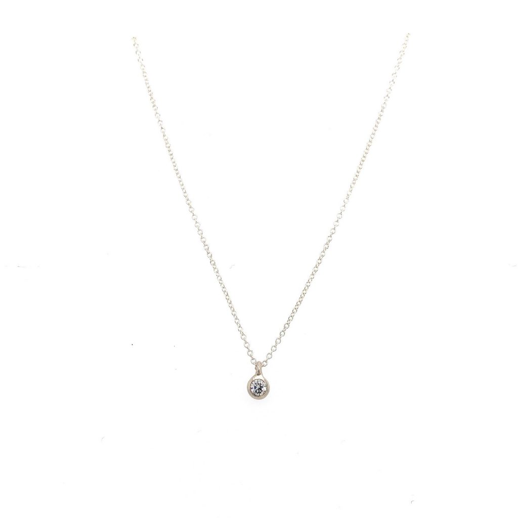 Just a Diamond Necklace with a 12 point diamond set in a matte finishe bezel.