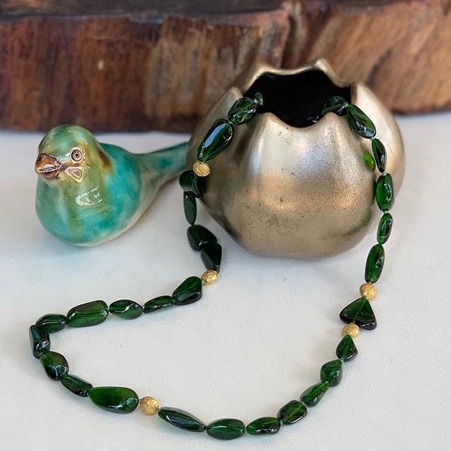 green and gold beaded necklace with tea bird and gold vase